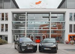SIXT BMWiX and Tesla Model Y in front of SIXT Headquarters in Pullach landscape