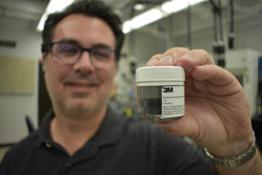 3m powder product in container held by researcher